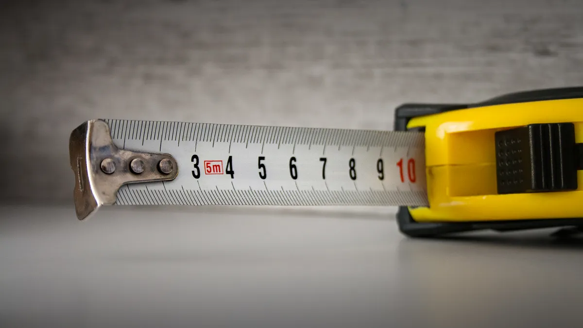 Carry-On Size Guide: Airline Rules, Measurements, and Fit Tape measure stretched out