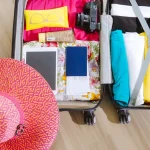 open suitcase packed with clothes and travel items